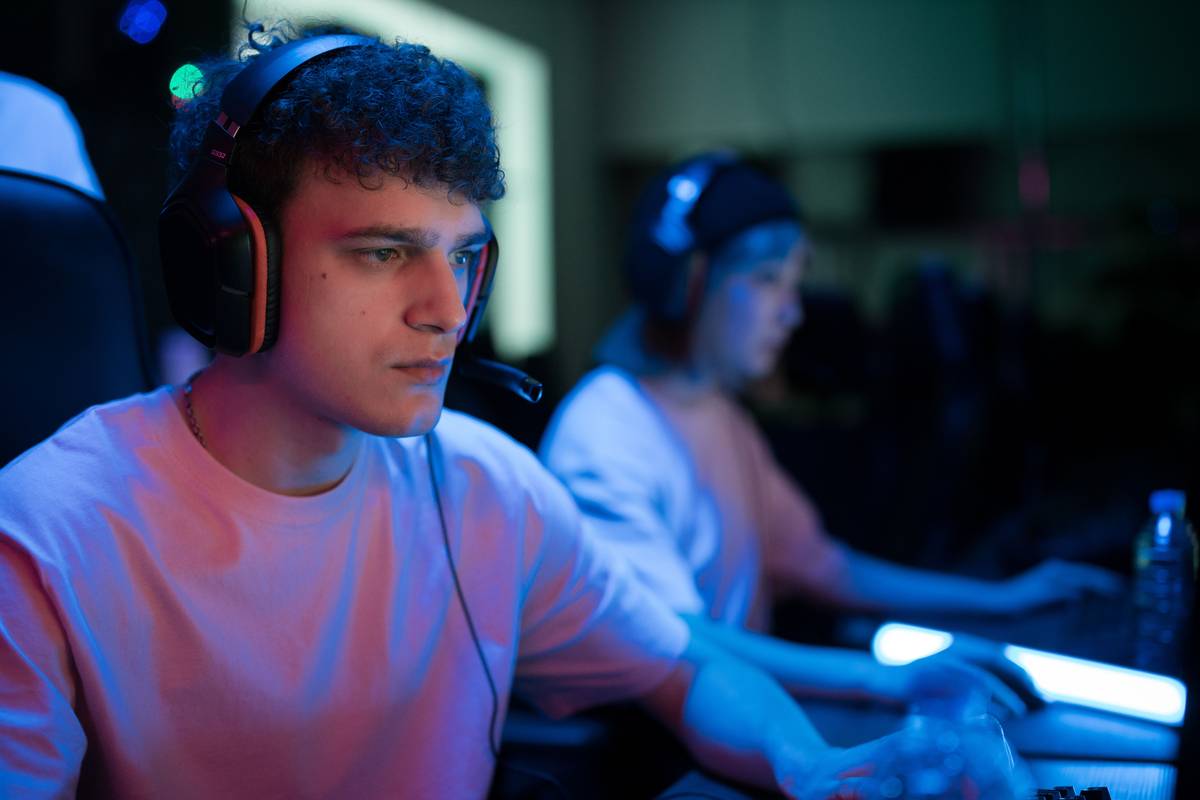 Front-facing streaming setup showing balanced key, fill, and backlight positioning with visible facial detail and zero harsh shadows — lighting solution light is gaming better